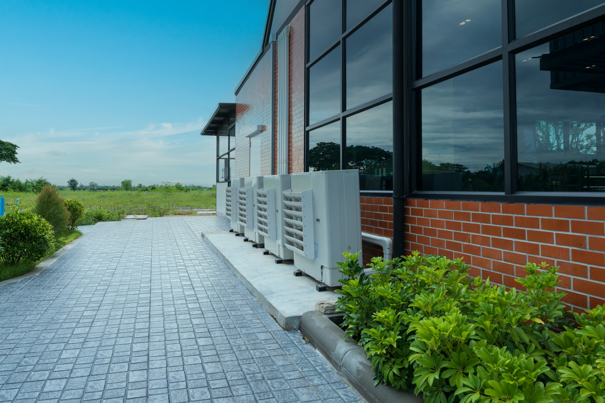 Air compressor or condenser unit installed outside building