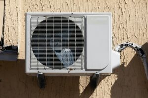 outdoor air conditioner unit on the wall of a building